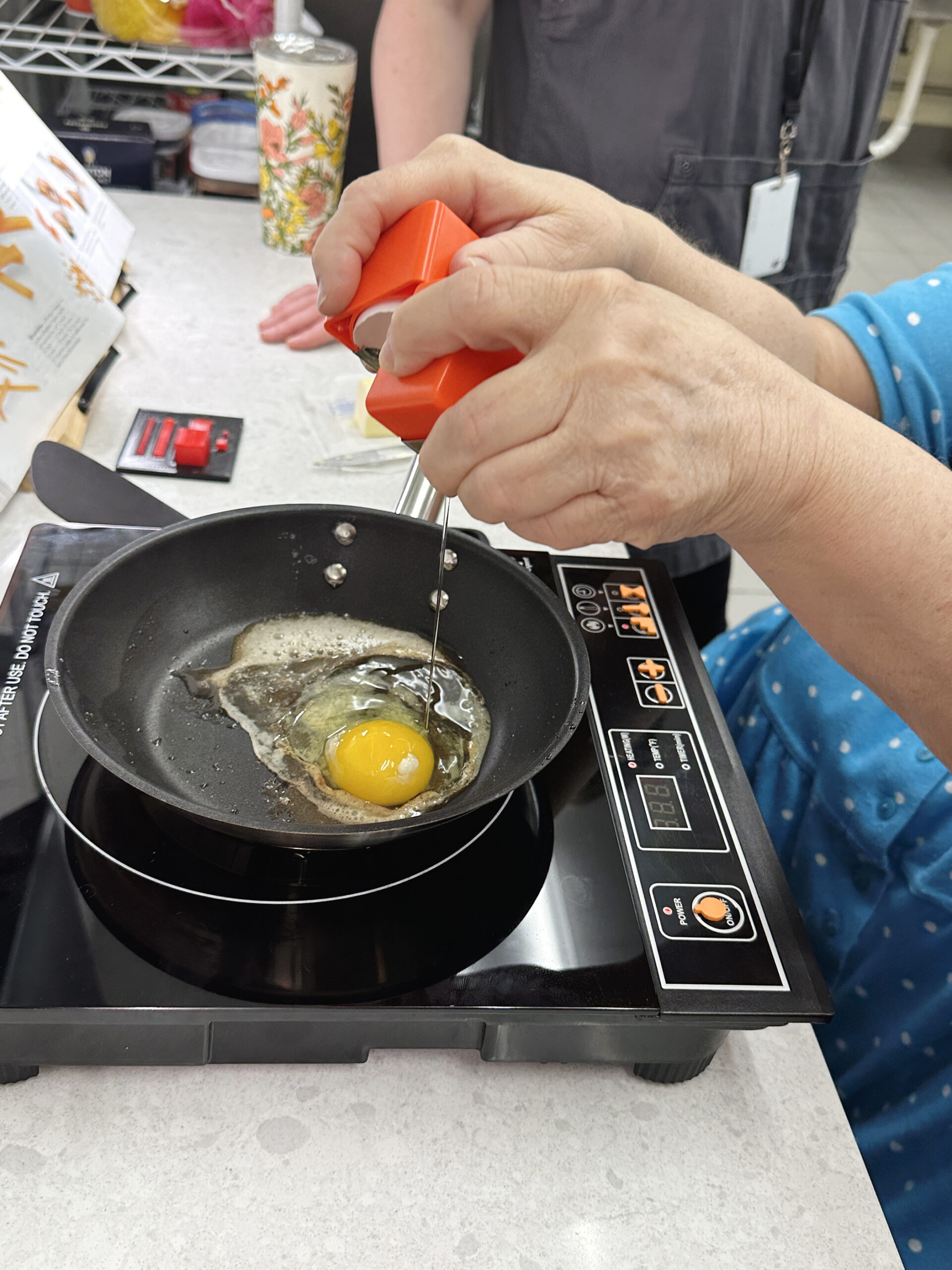 IATP Customer Using an Egg Cracker IATP Customer Using an Egg Cracker